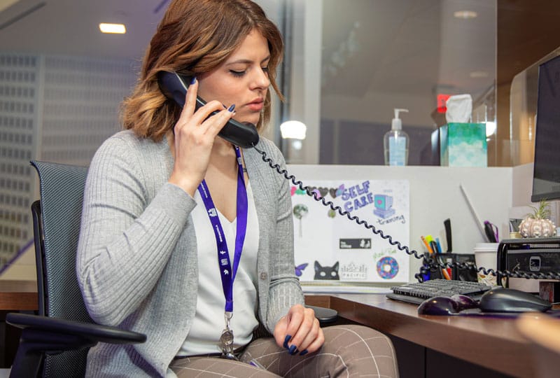 woman talking on phone at desk
