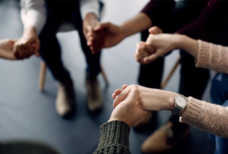 group of people holding hands