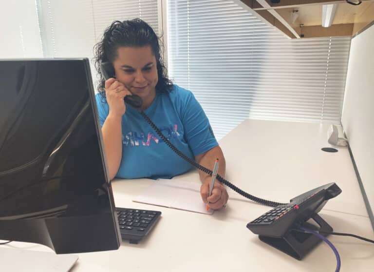 woman taking phone call at desk